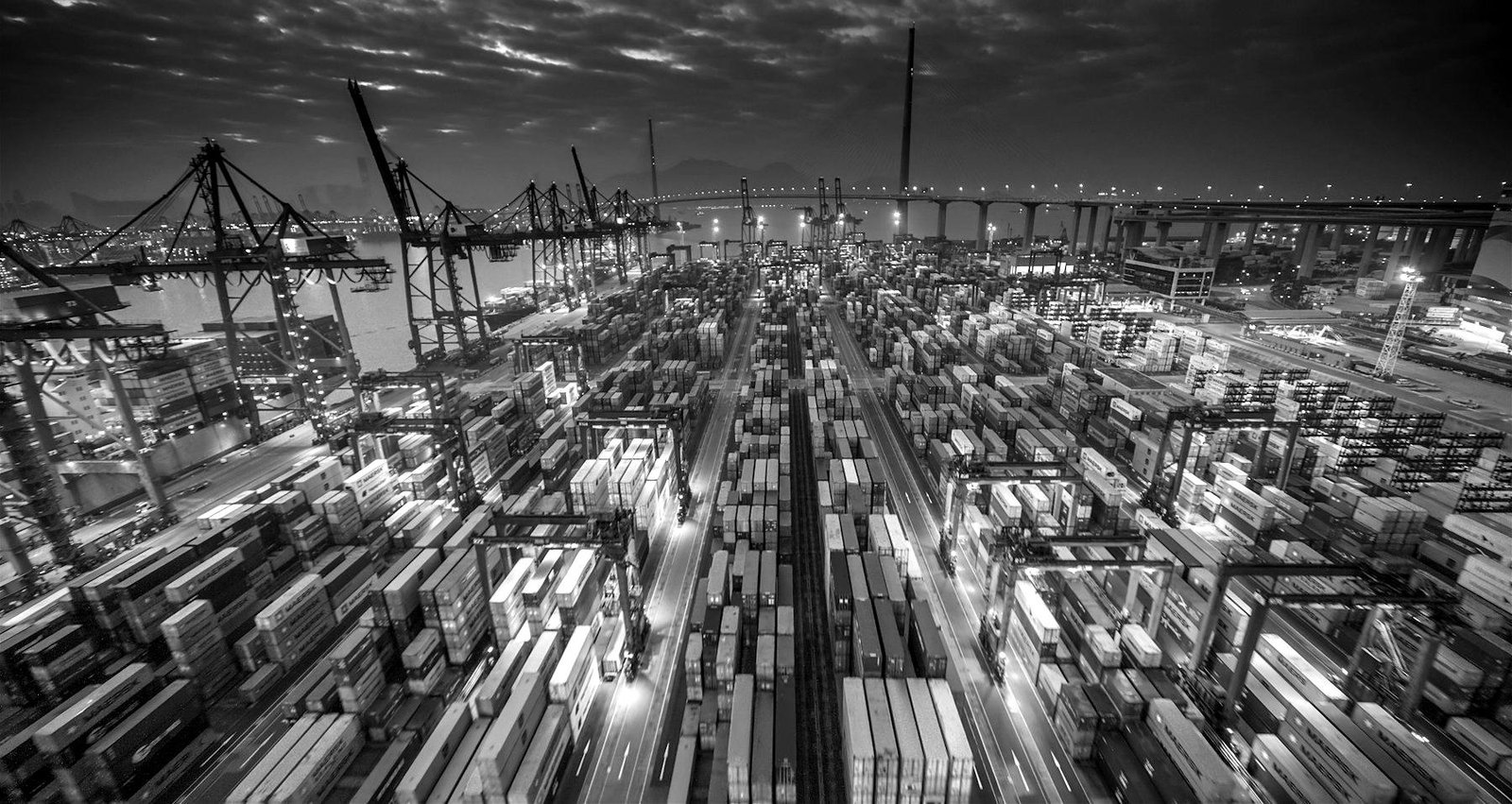 Container port with cranes at dusk