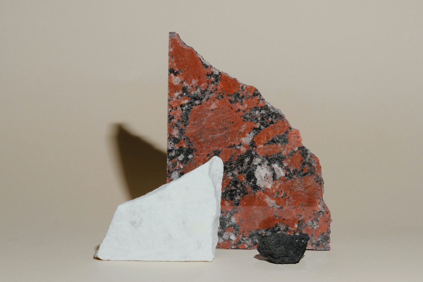 Three stone samples on a plain background